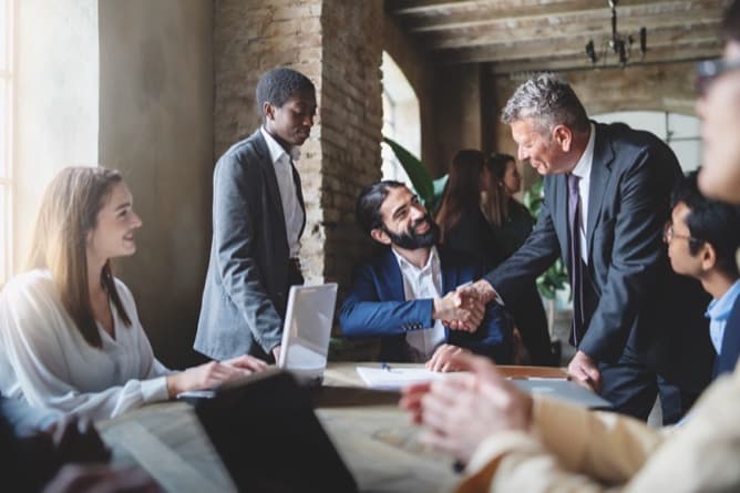 Business professionals shaking hands on deal